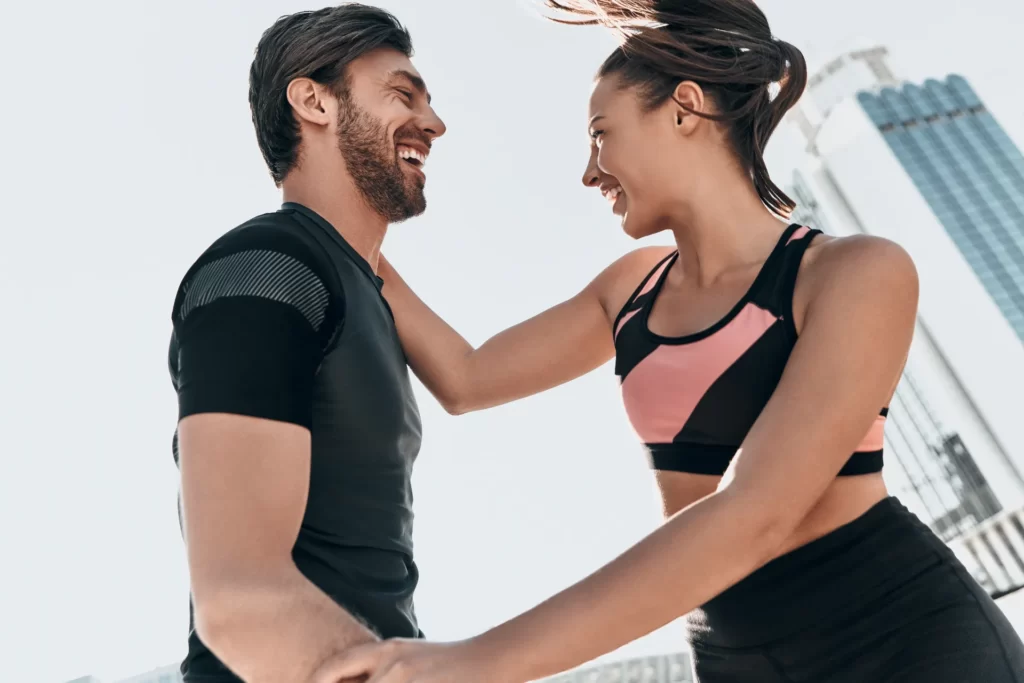 smiling man and woman together after exercise utc