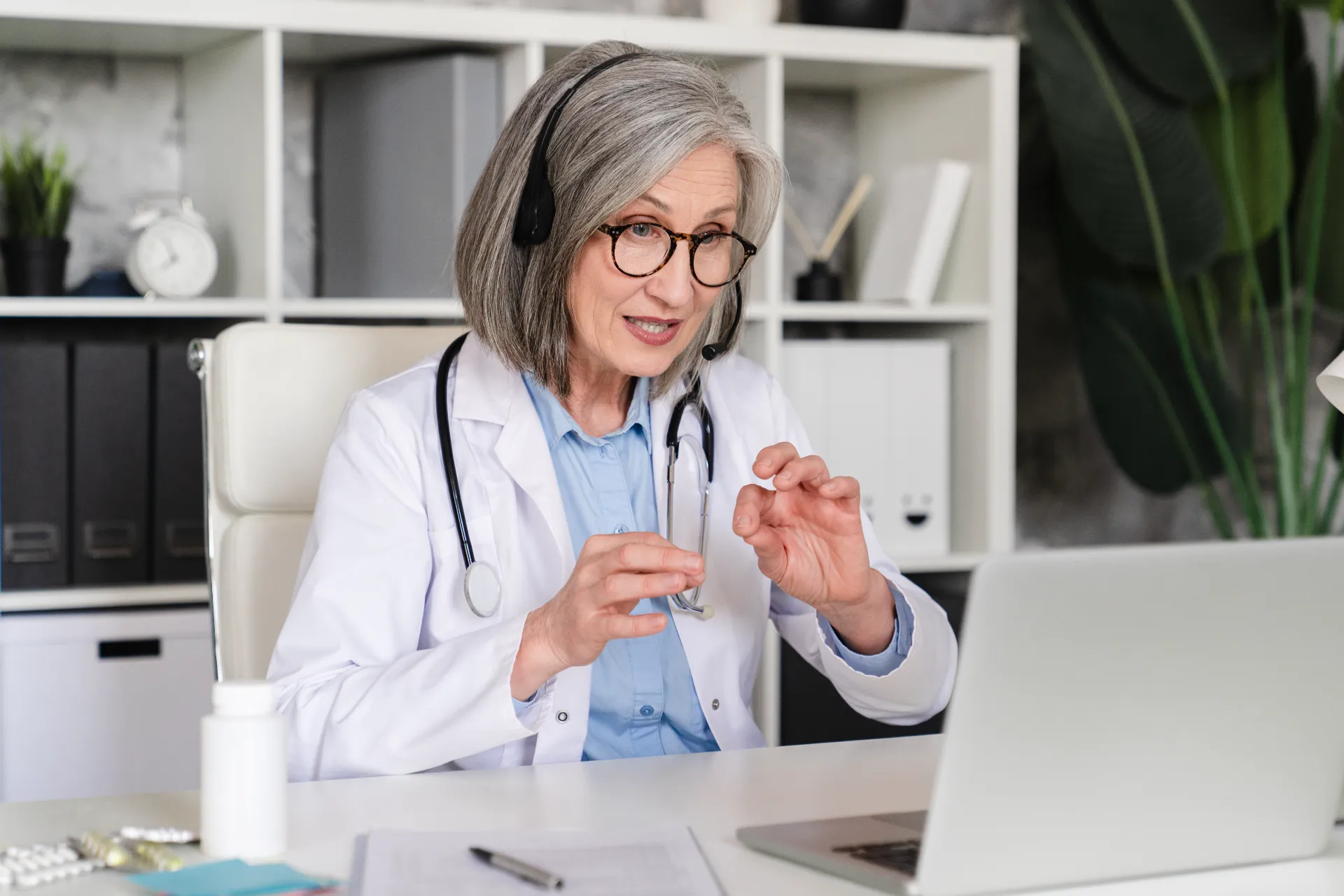mature woman doctor engaged in telemedicine appoin utc