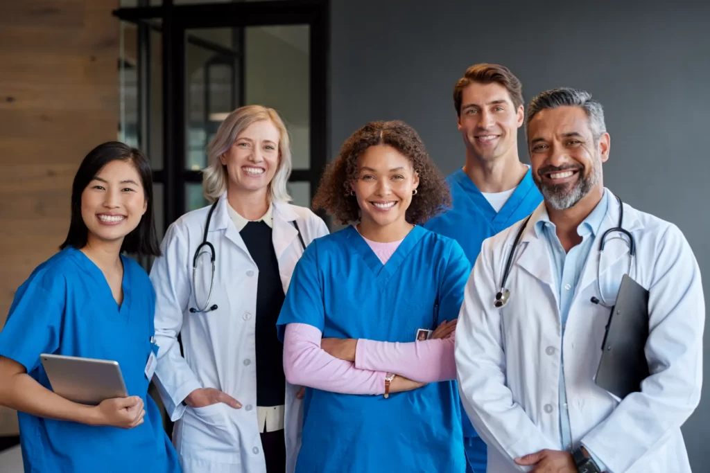 smiling medical team in hospital setting posing to utc
