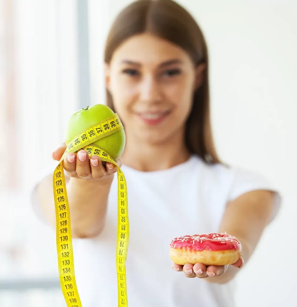diet concept woman holding a choice of harmful do utc