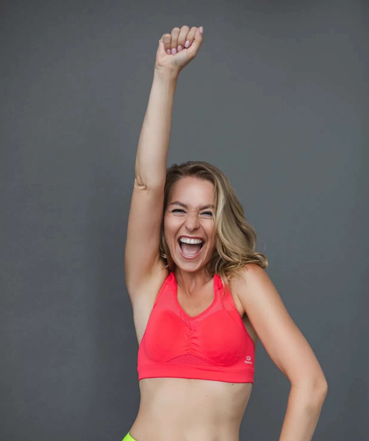 happy fit woman in sportswear with arm up utc
